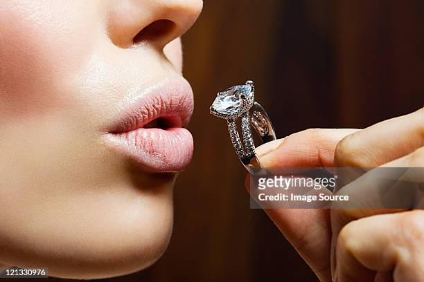 young woman holding engagement ring - precious gem stock pictures, royalty-free photos & images