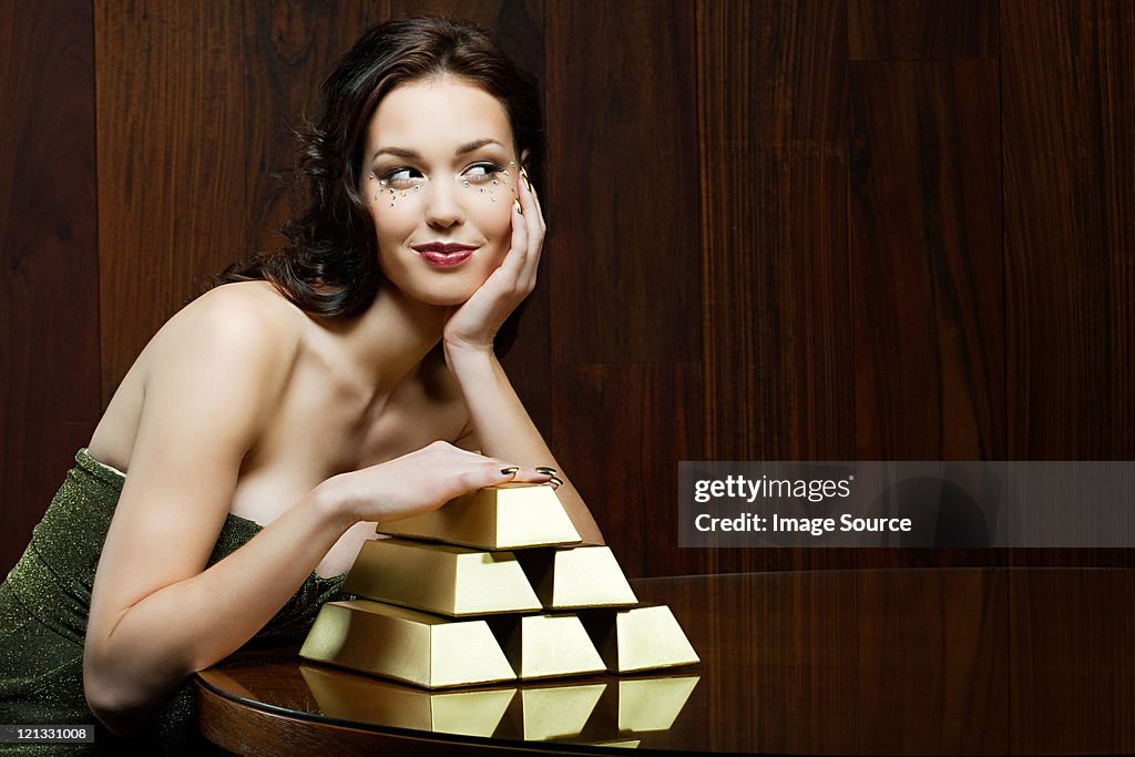 Young woman with gold ingots