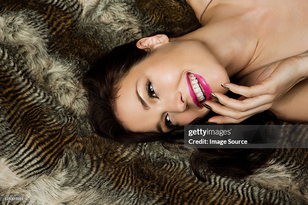 Young woman lying on manta, vertical