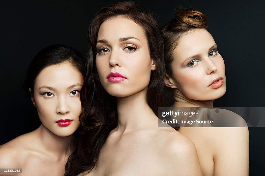 Three women wearing lipstick, portrait