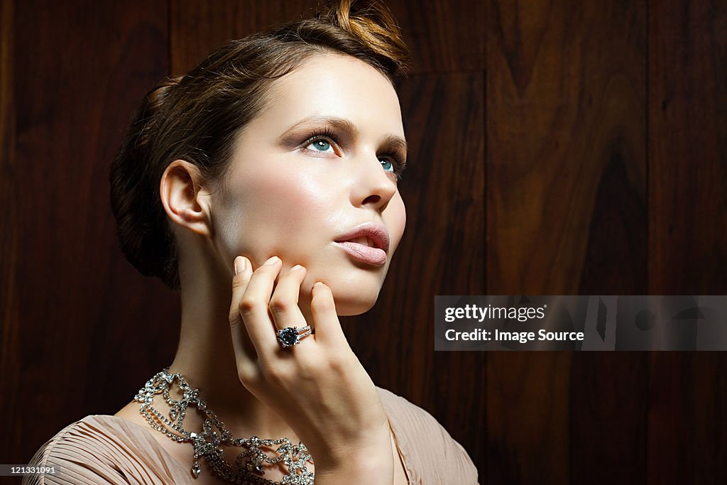 Young woman wearing ring, portrait
