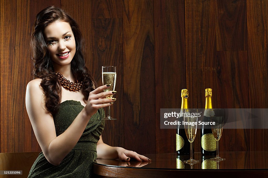 Young woman with glass of champagne, portrait