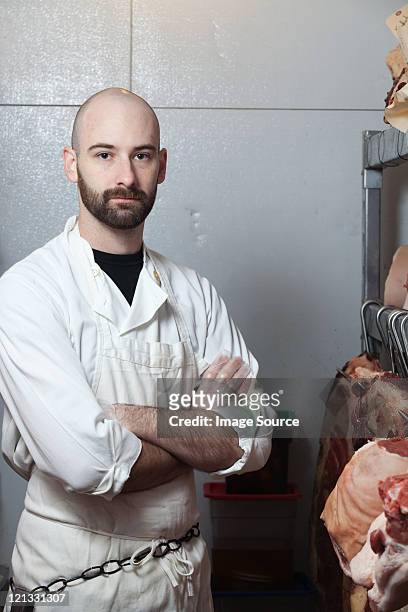 butcher in meat storage area - butcher portrait stock pictures, royalty-free photos & images