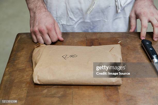 butcher with package of ribs - food covered stock pictures, royalty-free photos & images