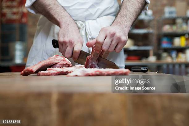 butcher preparing pork ribs - pork cuts stock pictures, royalty-free photos & images