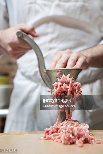 butcher making mince - trituradora de carne fotografías e imágenes de stock