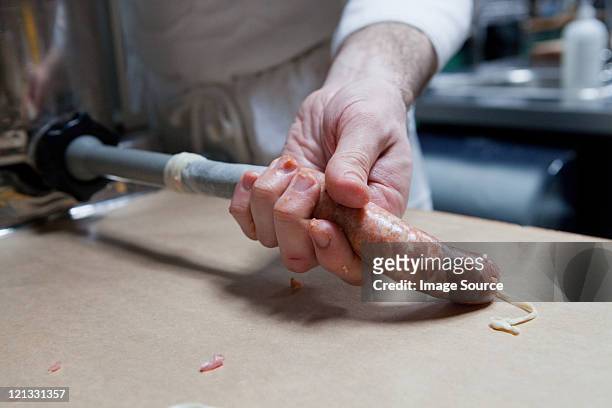 butcher making a sausage - sausage stock pictures, royalty-free photos & images
