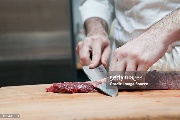 butcher preparing beef tenderloin - metzger stock-fotos und bilder