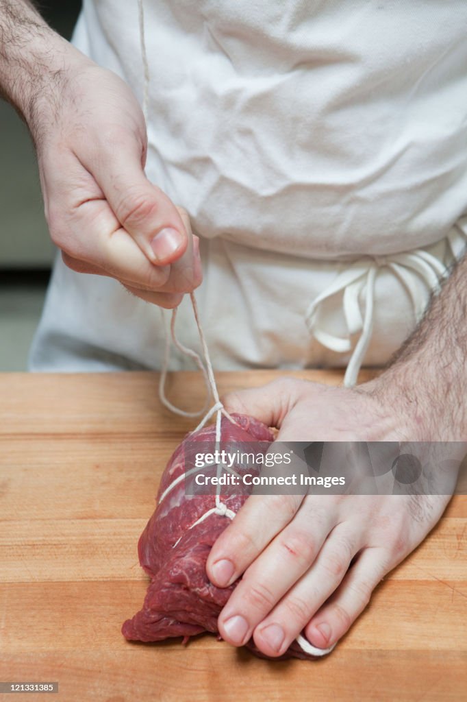 String For Butcher Butcher Tying Beef Tenderloin With String High-Res Stock Photo - Getty ...