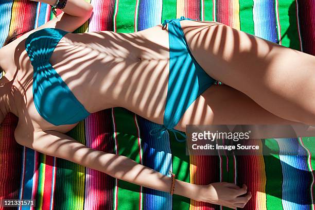 woman lying on ethnic style blanket - hot puerto rican women stock-fotos und bilder