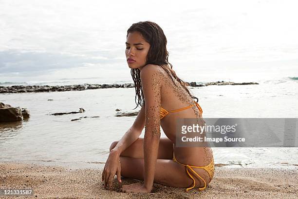 woman sitting on beach - hot puerto rican women stock pictures, royalty-free photos & images