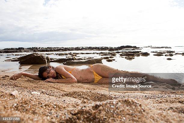 woman lying on beach - hot puerto rican women stock pictures, royalty-free photos & images