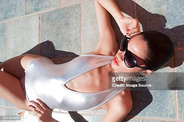woman wearing sunglasses and sexy silver swimsuit - hot puerto rican women stock pictures, royalty-free photos & images