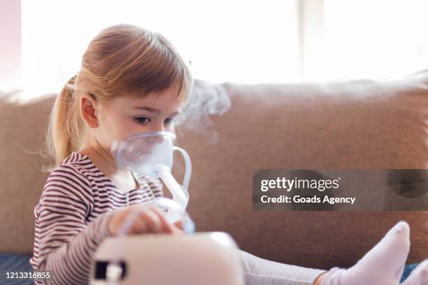 ernstig jong meisje op inhalatie - zichtbare adem stockfoto's en -beelden