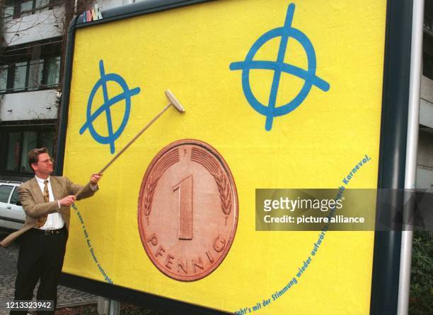 Als "Plakatkleber" betätigt sich Guido Westerwelle am 14.2.1996 vor dem Thomas-Dehler Haus in Bonn. Das Plakat zeigt einen symbolischen Pfennig und...