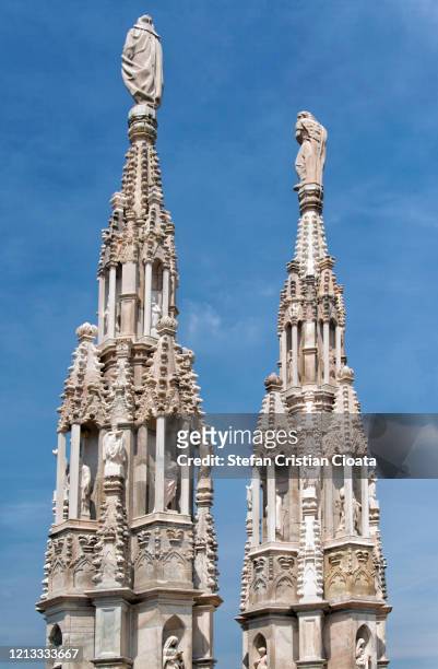 towers of the ancient duomo di milano cathedral in milano, italy. - catedral de milán fotografías e imágenes de stock
