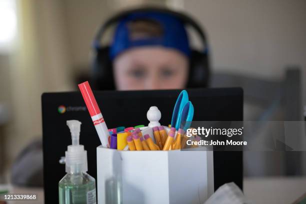 Cam Eaton works on a Chromebook during home schooling on March 18, 2020 in New Rochelle, New York. Schools in New Rochelle, a hot spot in the U.S....