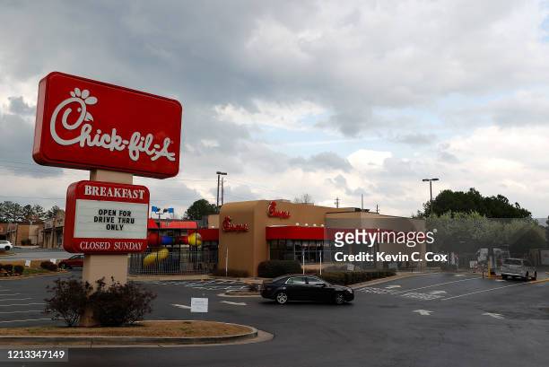 View of Chick-fil-A on Austell Road as customers pull around for their drive-thru orders on March 18, 2020 in Austell, Georgia. All locations across...