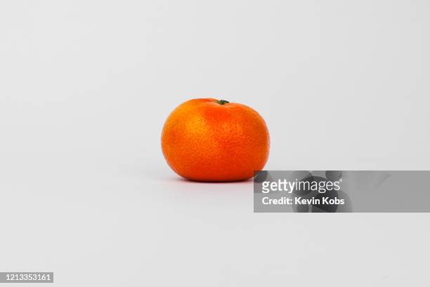 close up of a nadorcott mandarin / tangerine in a photo studio. - tangerine stock pictures, royalty-free photos & images