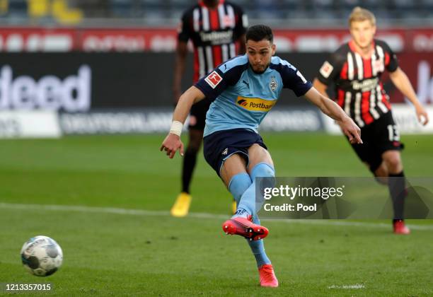 Ramy Bensebaini of Borussia Moenchengladbach shoots a penalty, to score his sides third goal during the Bundesliga match between Eintracht Frankfurt...