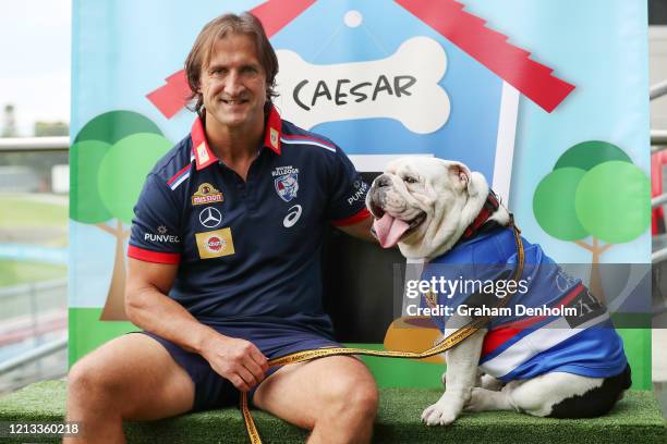 Western Bulldogs head coach Luke Beveridge poses with club mascot Caesar during a Western Bulldogs AFL media opportunity at Whitten Oval on March 19,...