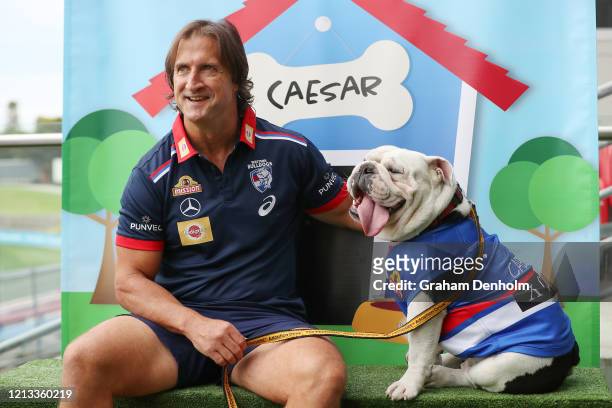 Western Bulldogs head coach Luke Beveridge poses with club mascot Caesar during a Western Bulldogs AFL media opportunity at Whitten Oval on March 19,...