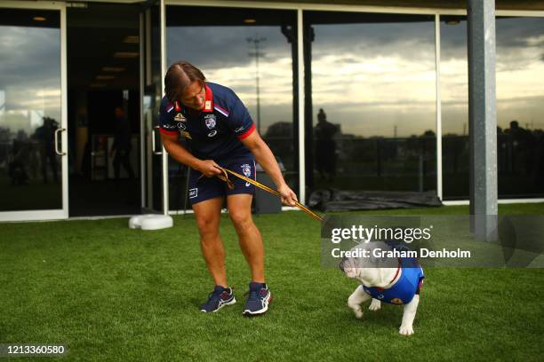 Western Bulldogs head coach Luke Beveridge arrives with club mascot Caesar during a Western Bulldogs AFL media opportunity at Whitten Oval on March...