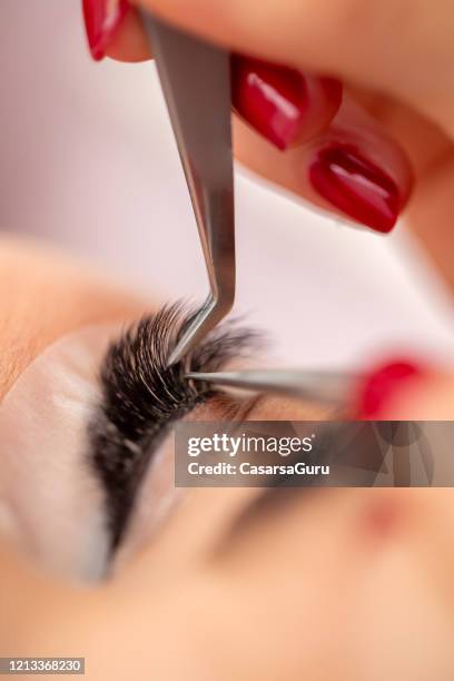 close-up of eyelash extension application - stock photo - eyelash extensions stock pictures, royalty-free photos & images