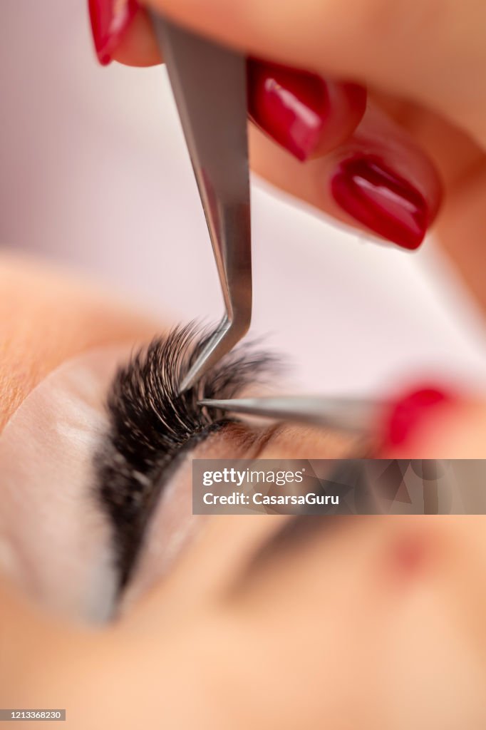 Close-up of Eyelash Extension Application - stock photo