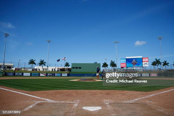 Grounds crew workers clean up the field after the Grapefruit League spring training game between the Washington Nationals and the New York Yankees at...