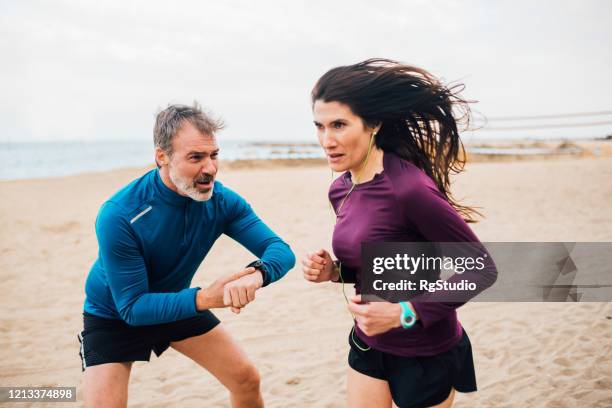 woman and her coach on the beach training - coach cheering stock pictures, royalty-free photos & images