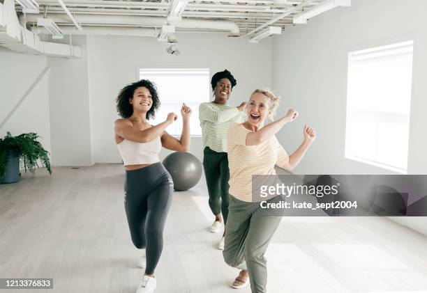 senior woman attending dance class that recreates the original moves  at a lower-intensity. - group gym class stock pictures, royalty-free photos & images