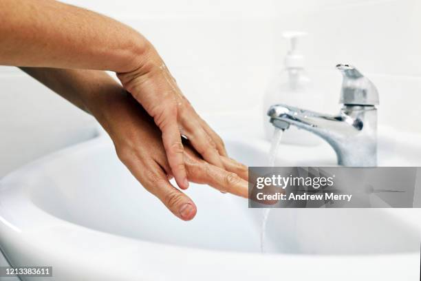 washing hands, coronavirus covid-19 pandemic prevention of infectious diseases - washing hands close up stock pictures, royalty-free photos & images