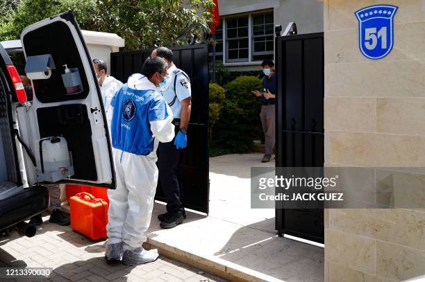 Israeli police abd forensic experts gather in front of the residence of Israel's Chinese ambassador on the outskirts of Tel Aviv, after he was found...