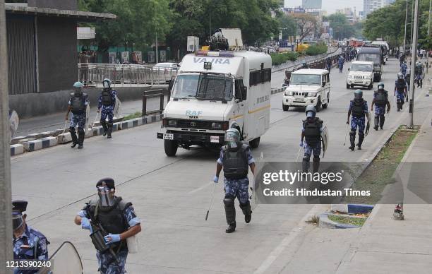 Rapid Action Force and Pune police personnel on a flag march along Pune-Satara road from Sahkarnagar police station to Dhankawadi, on May 15, 2020 in...