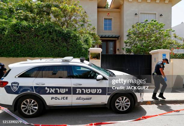 An Israeli policeman stands guard outside the cordoned-off gated house of the Chinese ambassador where he was found dead, in Herzliya on the...