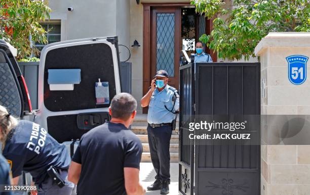 Members of the police gather at the entrance of the residence of Israel's Chinese ambassador on the outskirts of Tel Aviv after he was found dead on...