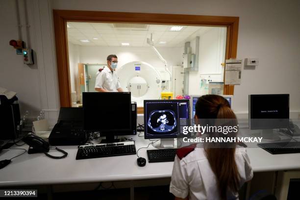 Medical staff prepare to receive a patient for a CT Scan at the Royal Blackburn Teaching Hospital in Blackburn, north-west England on May 14 as...