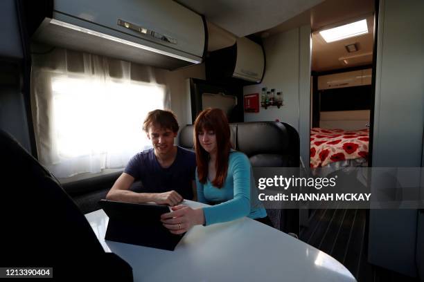 Junior Doctors, Jared Leggett and Amy Kitchen watch a film on an iPad in their motorhome they are living in temporarily in the Royal Blackburn...