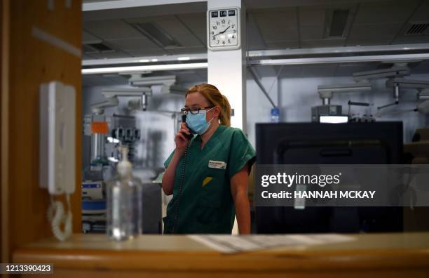 Pharmacist Susan Holgate wearing a protective face mask, talks on the telephone in the Critical Care Unit at the Royal Blackburn Teaching Hospital in...