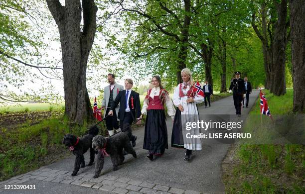 Crown Prince Haakon of Norway , Crown Princess Mette-Marit of Norway , Princess Ingrid Alexandra and Prince Sverre Magnus walk dogs during the May...