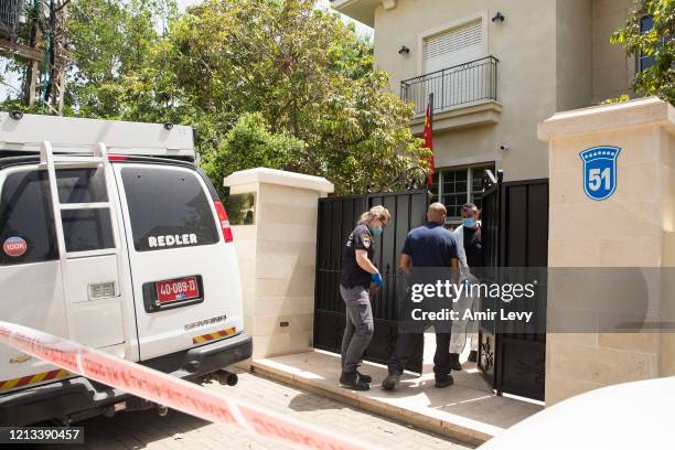 Israeli police workers enter the house of China's Ambassador to Israel Du Wei, after he was found dead in his house on May 17, 2020 in Herzliya,...