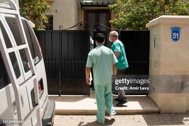 Head of Israel National Center of Forensic Medicine Dr Chen Kugel and a colleague enter the house of China's Ambassador to Israel Du Wei, after he...