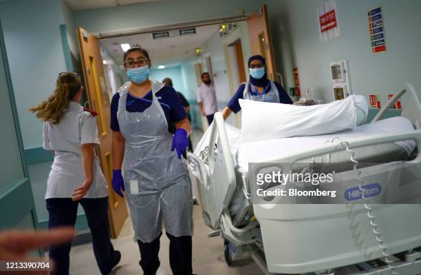 Medical staff transfer a patient along a corridor at The Royal Blackburn Teaching Hospital, operated by East Lancashire NHS Trust, in Blackburn,...