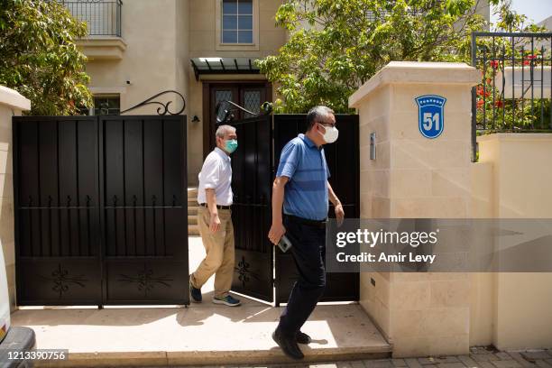 Two men leave the house of China's Ambassador to Israel Du Wei, after he was found dead in his house on May 17, 2020 in Herzliya, Israel. Du Wei was...