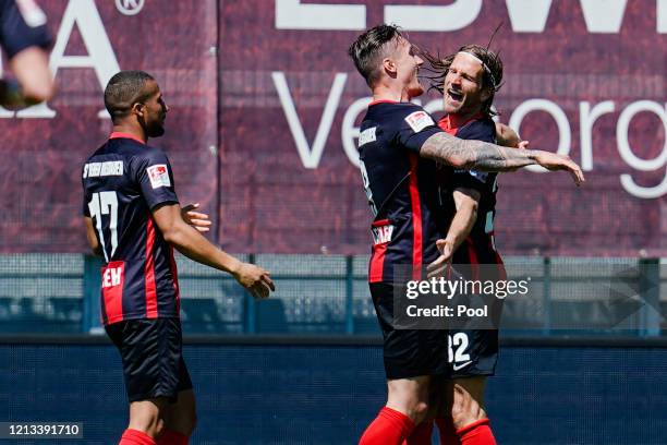 Manuel Schaeffler of SV Wehen Wiesbaden celebrates with teammate Stefan Aigner after scoring their side's first goal during the Second Bundesliga...