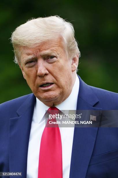 President Donald Trump walks across the South Lawn upon return to the White House in Washington, DC on May 17, 2020. - President Trump returned to...