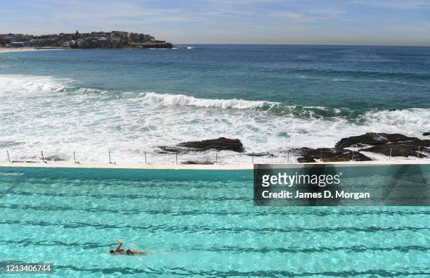 People enjoying a swim at Icebergs pool at Bondi Beach on March 19, 2020 in Sydney, Australia. Non-essential gatherings of 100 or more people indoors...