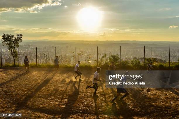 Boys play soccer at favela Aglomerado da Serra on May 17, 2020 in Belo Horizonte, Brazil. According to the Brazilian Health Ministry, Brazil has over...