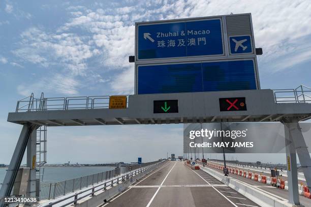 Road sign for Zhuhai across the border in mainland China and for Macau is seen on the way to the Hong Kong side of the Hong Kong-Zhuhai-Macau Bridge...